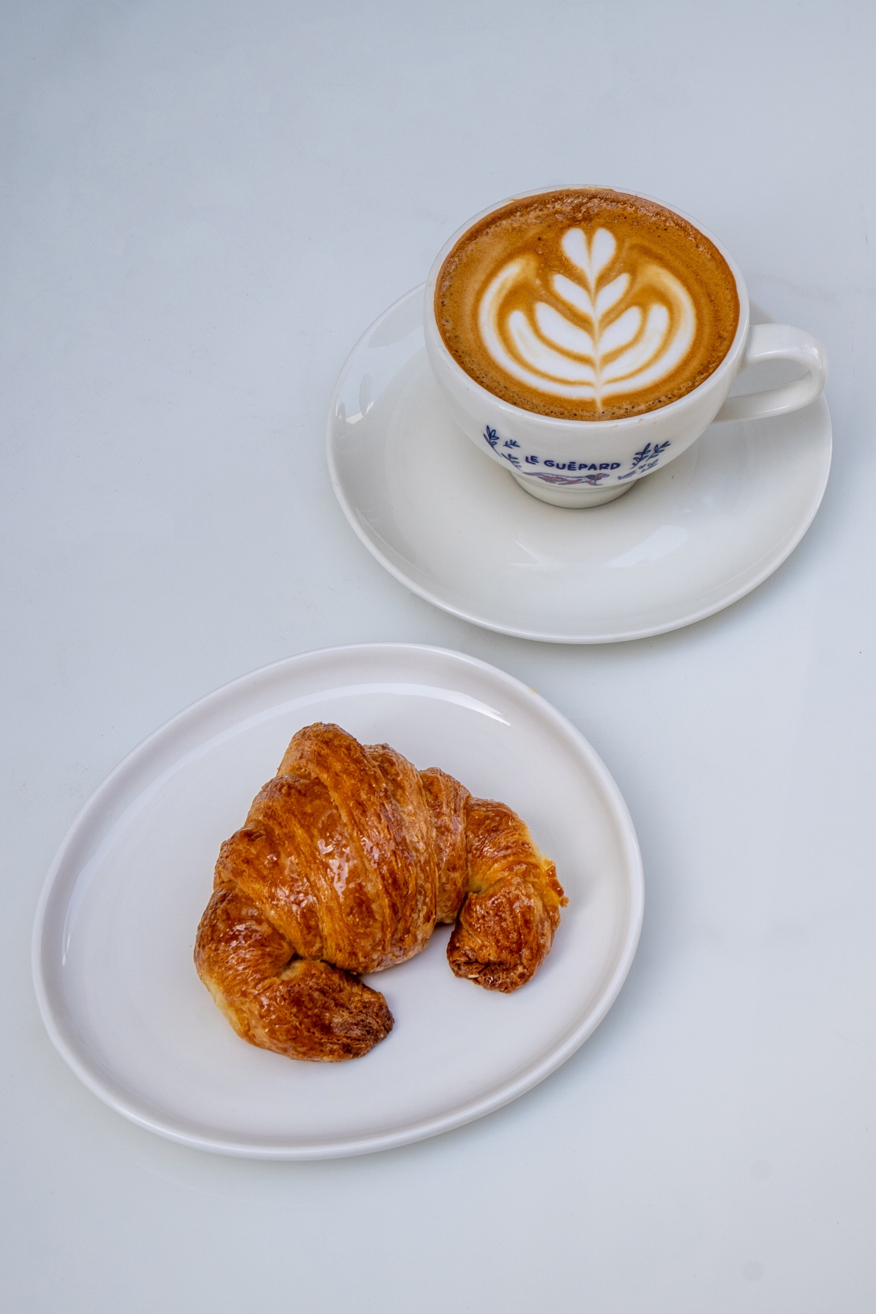 Medialuna with latte art coffee